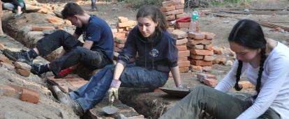 Volunteers laying bricks as part of the foundation at the Building Project in Nepal for groups Projects Abroad volunteers laying bricks to make a sturdy school at the Building Project in Nepal for groups